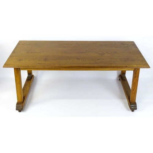 1453 - An early 20thC Heals style pine dining table with a rectangular moulded top above four straight legs... 