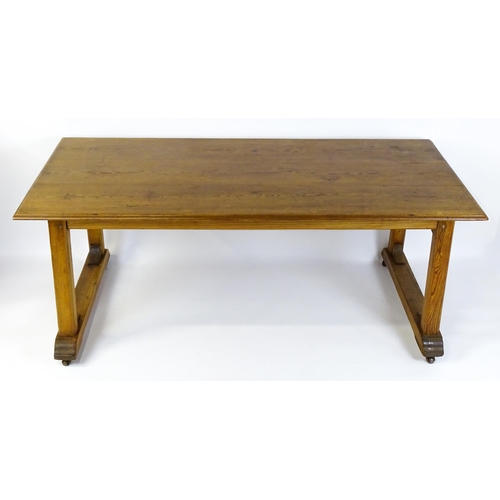 1453 - An early 20thC Heals style pine dining table with a rectangular moulded top above four straight legs... 