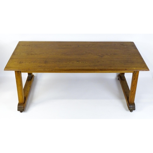 1453 - An early 20thC Heals style pine dining table with a rectangular moulded top above four straight legs... 