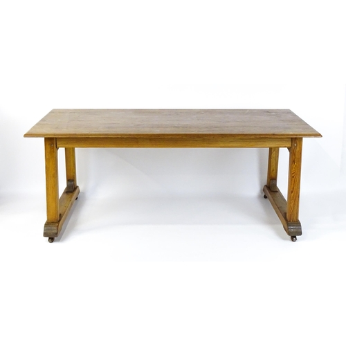 1453 - An early 20thC Heals style pine dining table with a rectangular moulded top above four straight legs... 