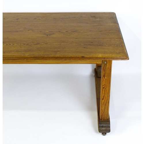 1453 - An early 20thC Heals style pine dining table with a rectangular moulded top above four straight legs... 