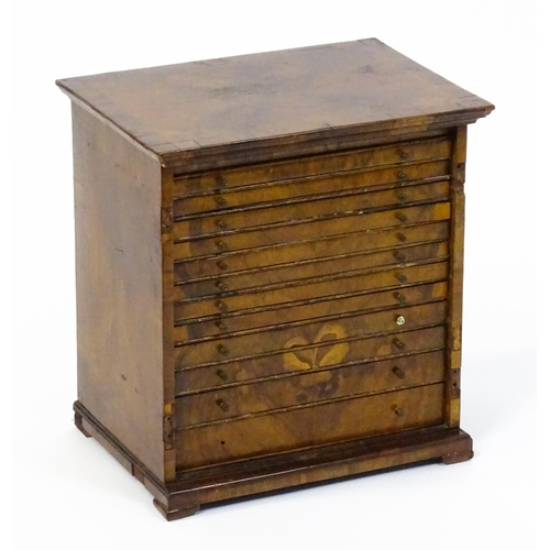 1464 - A Georgian walnut collectors cabinet with a moulded top above twelve short drawers. 16