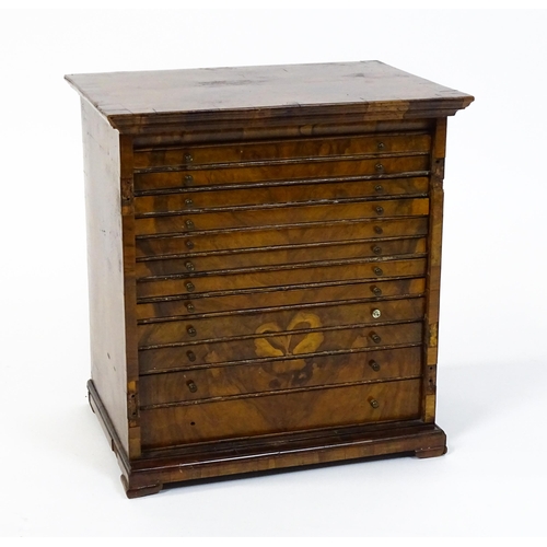 1464 - A Georgian walnut collectors cabinet with a moulded top above twelve short drawers. 16