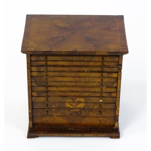 1464 - A Georgian walnut collectors cabinet with a moulded top above twelve short drawers. 16