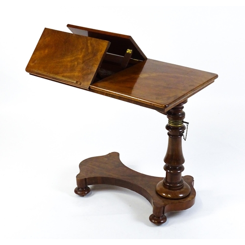 1471 - A Victorian mahogany reading table / invalid table, with an adjustable top having two adjustable slo... 