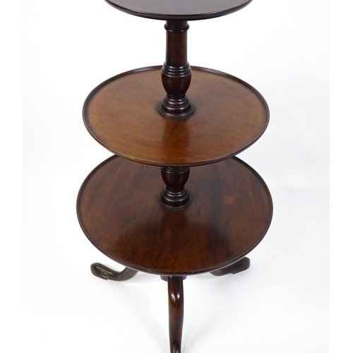 1477 - A Georgian mahogany dumb waiter with three circular tiers raised on a turned pedestal and three cabr... 