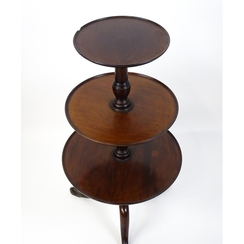 1477 - A Georgian mahogany dumb waiter with three circular tiers raised on a turned pedestal and three cabr... 