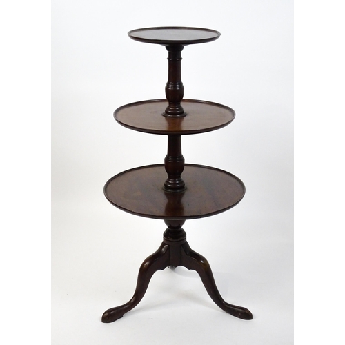 1477 - A Georgian mahogany dumb waiter with three circular tiers raised on a turned pedestal and three cabr... 