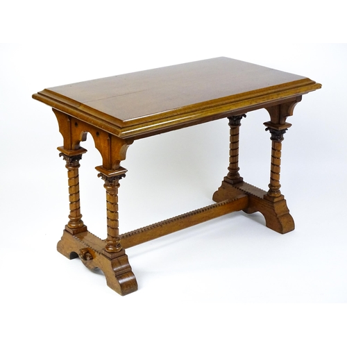 1479 - A Victorian Gothic oak table with a double moulded top edge above four turned columns with composite... 