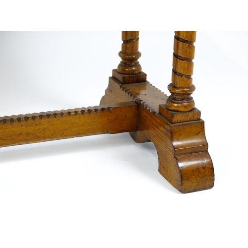 1479 - A Victorian Gothic oak table with a double moulded top edge above four turned columns with composite... 