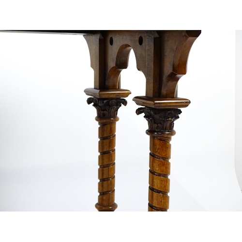 1479 - A Victorian Gothic oak table with a double moulded top edge above four turned columns with composite... 