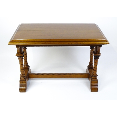 1479 - A Victorian Gothic oak table with a double moulded top edge above four turned columns with composite... 