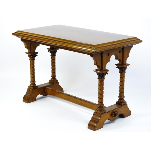 1479 - A Victorian Gothic oak table with a double moulded top edge above four turned columns with composite... 