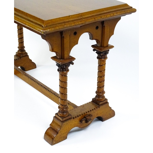 1479 - A Victorian Gothic oak table with a double moulded top edge above four turned columns with composite... 