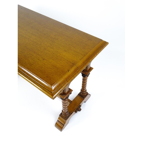 1479 - A Victorian Gothic oak table with a double moulded top edge above four turned columns with composite... 