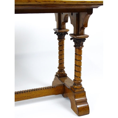 1479 - A Victorian Gothic oak table with a double moulded top edge above four turned columns with composite... 