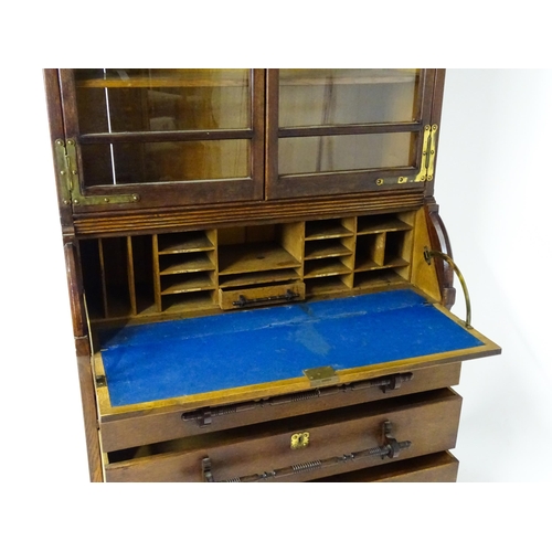 1480 - A late 19thC oak Arts & Crafts bureau bookcase with a pointed pediment above glazed doors and brass ... 