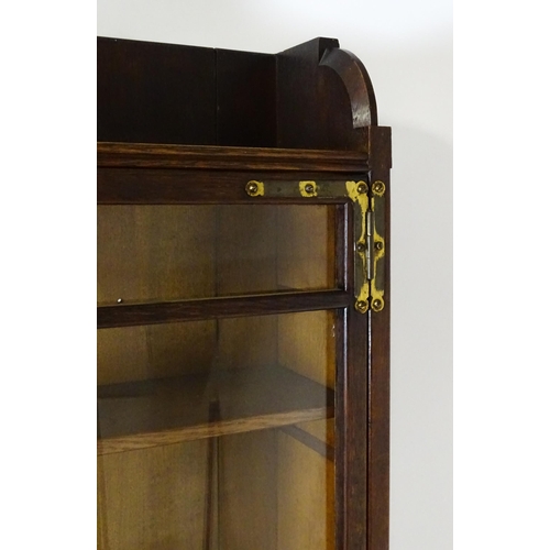 1480 - A late 19thC oak Arts & Crafts bureau bookcase with a pointed pediment above glazed doors and brass ... 