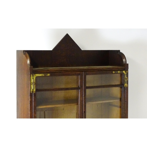 1480 - A late 19thC oak Arts & Crafts bureau bookcase with a pointed pediment above glazed doors and brass ... 