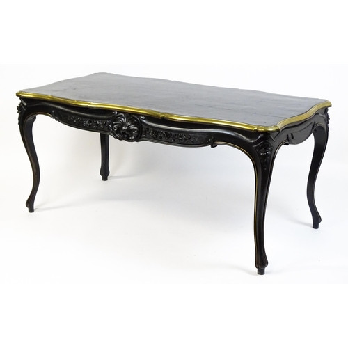 1486 - A late 19thC / early 20thC Louis XV style table with an ebonised finish and a brass rim, the table r... 