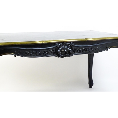 1486 - A late 19thC / early 20thC Louis XV style table with an ebonised finish and a brass rim, the table r... 