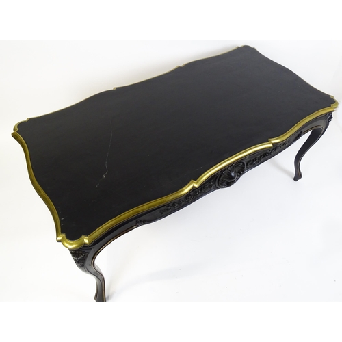 1486 - A late 19thC / early 20thC Louis XV style table with an ebonised finish and a brass rim, the table r... 