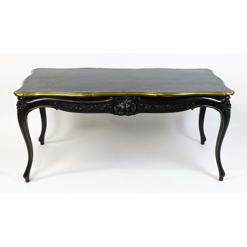 1486 - A late 19thC / early 20thC Louis XV style table with an ebonised finish and a brass rim, the table r... 