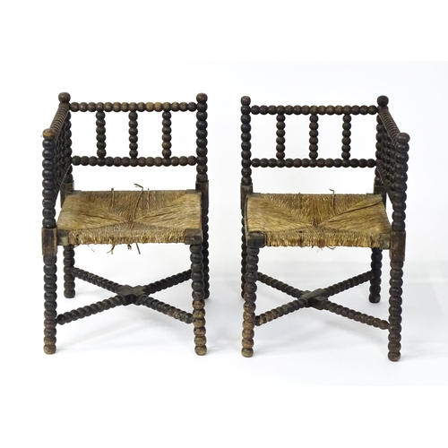 1492 - A pair of late 19thC English corner chairs with bobbin turned turning and rush seats. 23