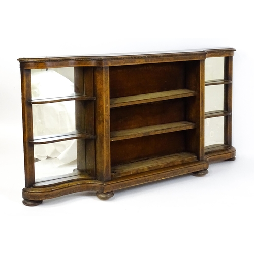 1505 - A Victorian walnut credenza with three open bookshelves and two mirrored back panels. The cabinet ha... 