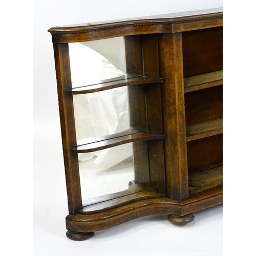 1505 - A Victorian walnut credenza with three open bookshelves and two mirrored back panels. The cabinet ha... 