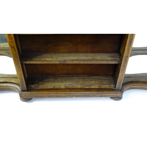 1505 - A Victorian walnut credenza with three open bookshelves and two mirrored back panels. The cabinet ha... 