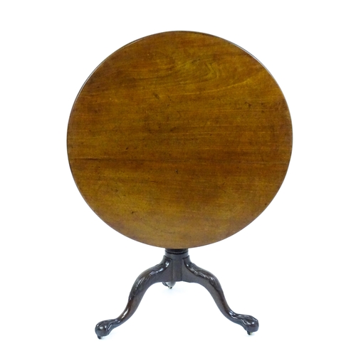 1507 - A George III mahogany tripod table with a circular top above a turned pedestal raised on three acant... 