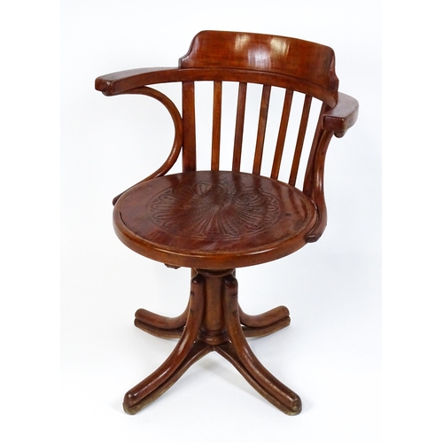 1516 - An early 20thC Thonet desk chair / revolving chair with a slatted backrest and embossed seat above a... 