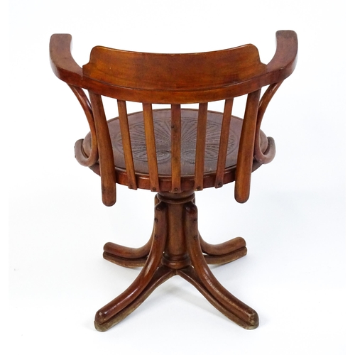 1516 - An early 20thC Thonet desk chair / revolving chair with a slatted backrest and embossed seat above a... 