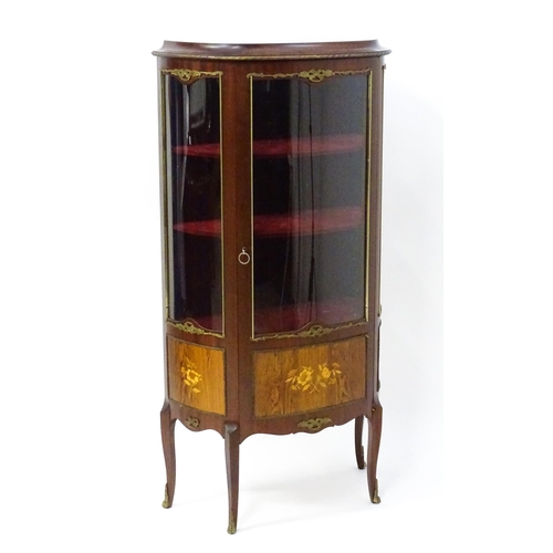 1519 - A mid century display cabinet / vitrine with gilt metal mounts above a single door containing three ... 