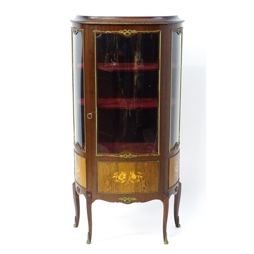 1519 - A mid century display cabinet / vitrine with gilt metal mounts above a single door containing three ... 