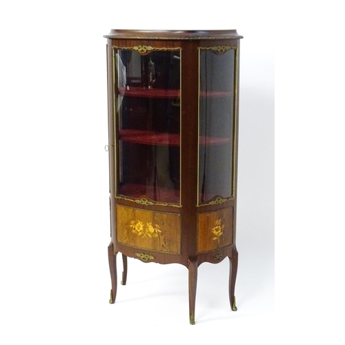 1519 - A mid century display cabinet / vitrine with gilt metal mounts above a single door containing three ... 