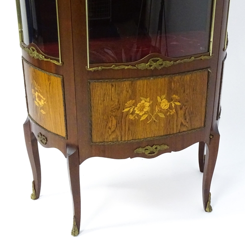 1519 - A mid century display cabinet / vitrine with gilt metal mounts above a single door containing three ... 