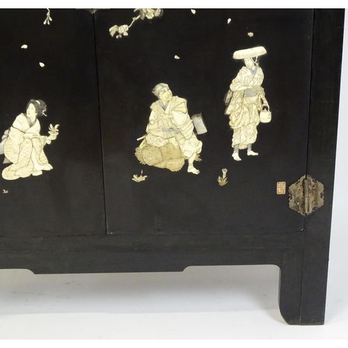 1520 - A late 19thC / early 20thC oriental cabinet with figural decoration to the doors. 48