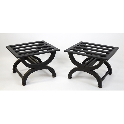 1521 - A pair of ebonised oak luggage racks / table / stools with slatted tops and raised on x-frame bases.... 