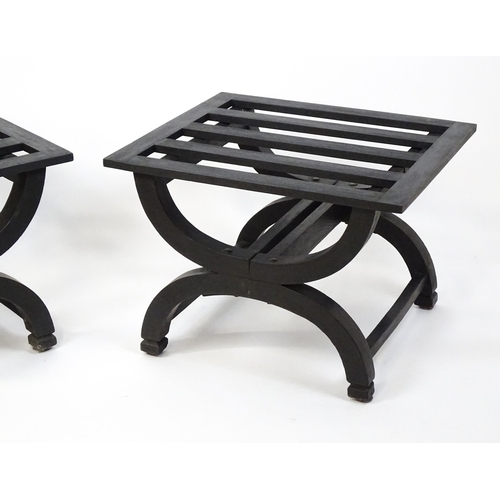 1521 - A pair of ebonised oak luggage racks / table / stools with slatted tops and raised on x-frame bases.... 