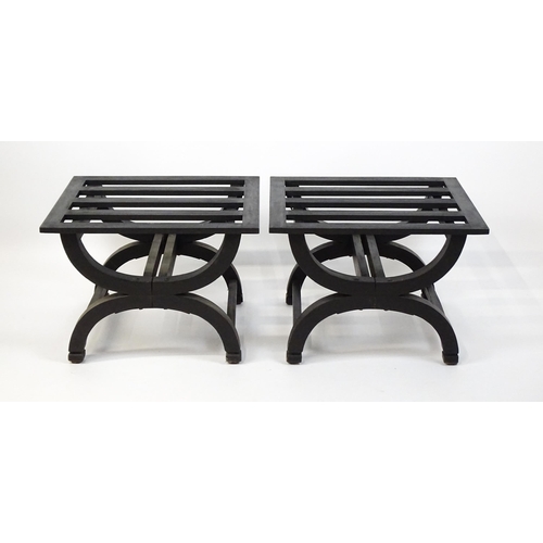 1521 - A pair of ebonised oak luggage racks / table / stools with slatted tops and raised on x-frame bases.... 