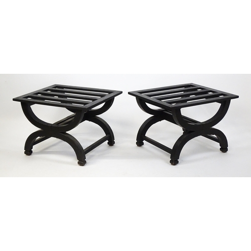 1521 - A pair of ebonised oak luggage racks / table / stools with slatted tops and raised on x-frame bases.... 