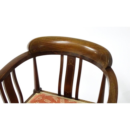 1527 - An Edwardian mahogany tub chair in the manner of E.A Taylor. The chair having boxwood inlaid decorat... 