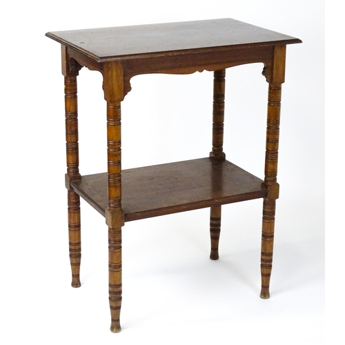 1534 - An Aesthetic movement mahogany two tier whatnot / etagere with a moulded top above four ring turned ... 