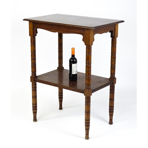 1534 - An Aesthetic movement mahogany two tier whatnot / etagere with a moulded top above four ring turned ... 