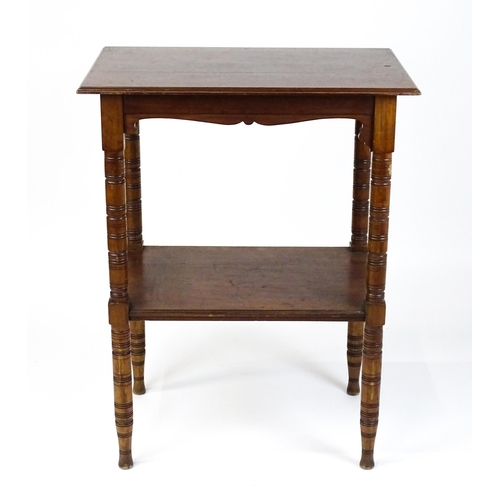 1534 - An Aesthetic movement mahogany two tier whatnot / etagere with a moulded top above four ring turned ... 