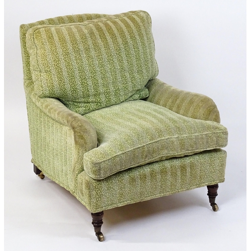 1558 - A 20thC George Smith style armchair with a deep seat raised on turned tapering legs and block back l... 