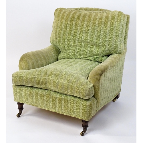 1558 - A 20thC George Smith style armchair with a deep seat raised on turned tapering legs and block back l... 