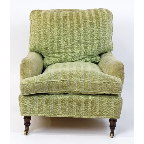 1558 - A 20thC George Smith style armchair with a deep seat raised on turned tapering legs and block back l... 